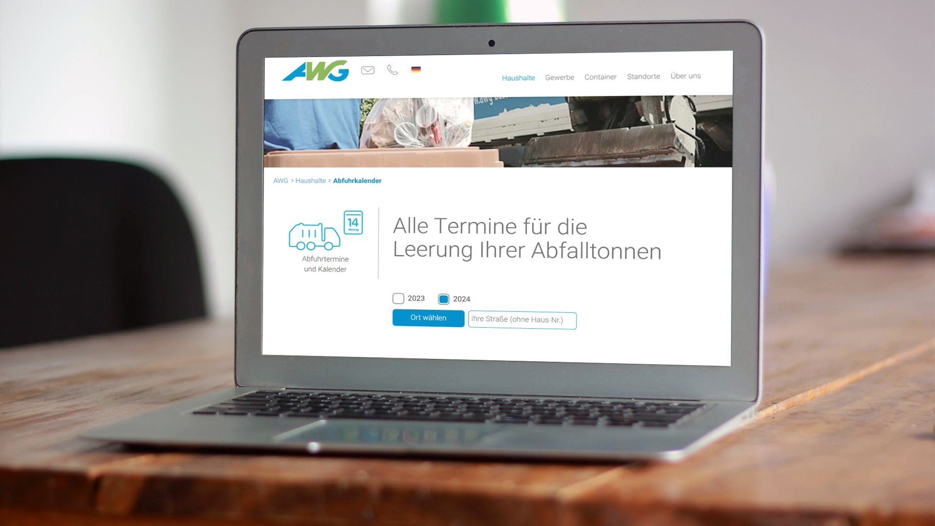 Laptop auf einem Tisch. Auf dem Bildschirm ist die AWG-Website abgebildet.